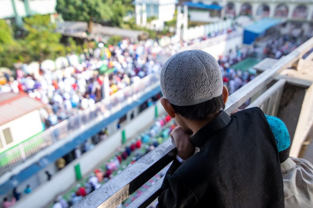 Boy seeing the people performing Eid al-Adha Prayer.