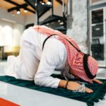 Man performing a Sajdah on a prayer mat showing the importance of Prayer in Islam.
