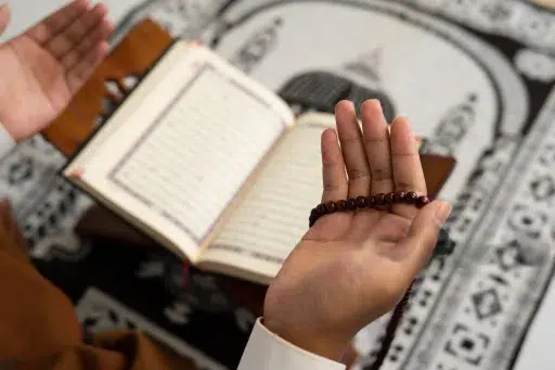 A Muslim man doing Istighfar and reciting Tasbih of Astaghfirullah