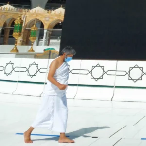 A man in Ihram clothing, embodying simplicity and spiritual readiness.