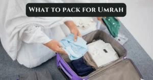 A pilgrim folding clothes into a suitcase while preparing for the journey, illustrating what to pack for Umrah.